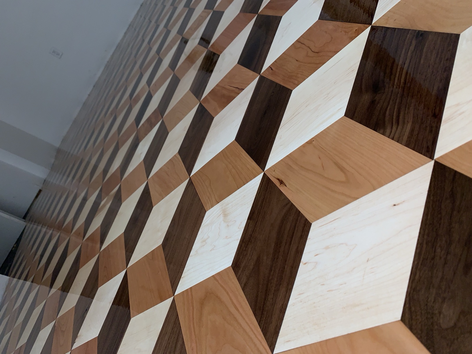 Custom three-dimensional cube parquet floor in walnut, cherry, and maple